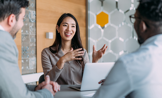 Asian woman in a meeting with two men