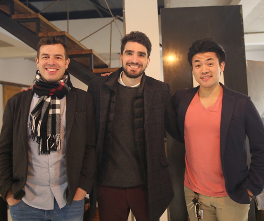 Three men smiling