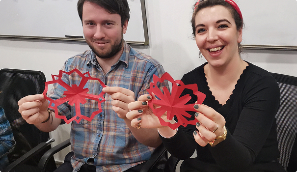 Man and woman holding Chinese paper cuttings