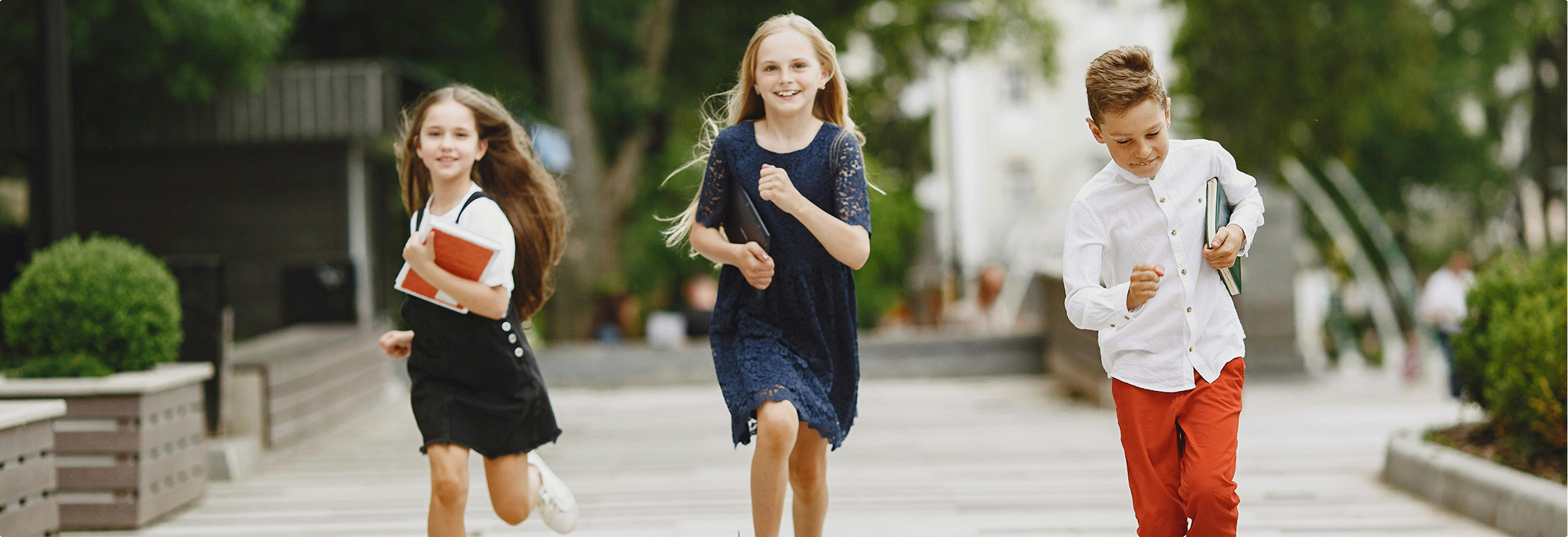 Three young children happily running