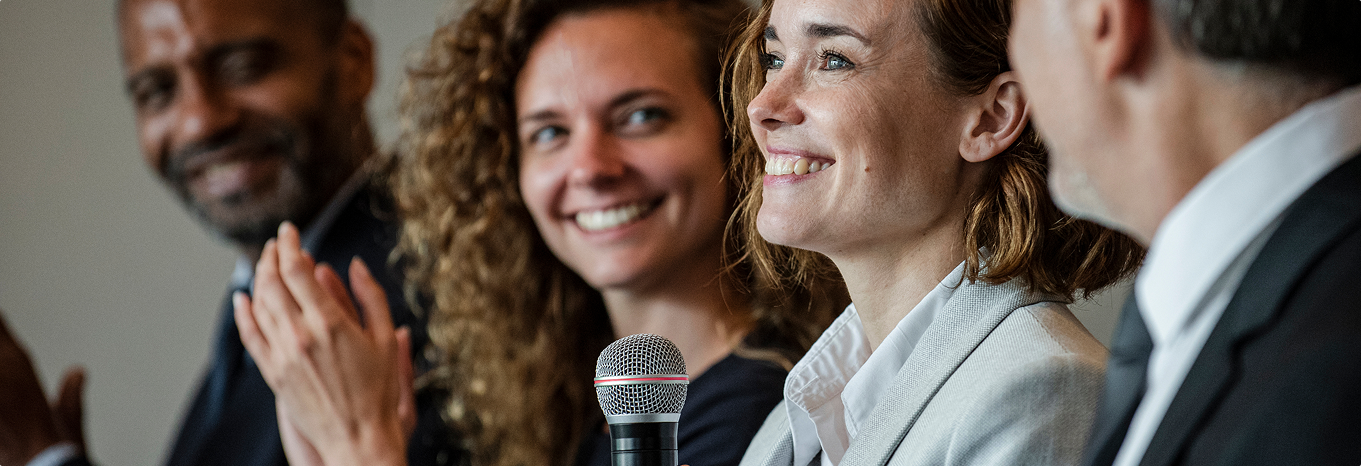 Woman smiling holding microphone